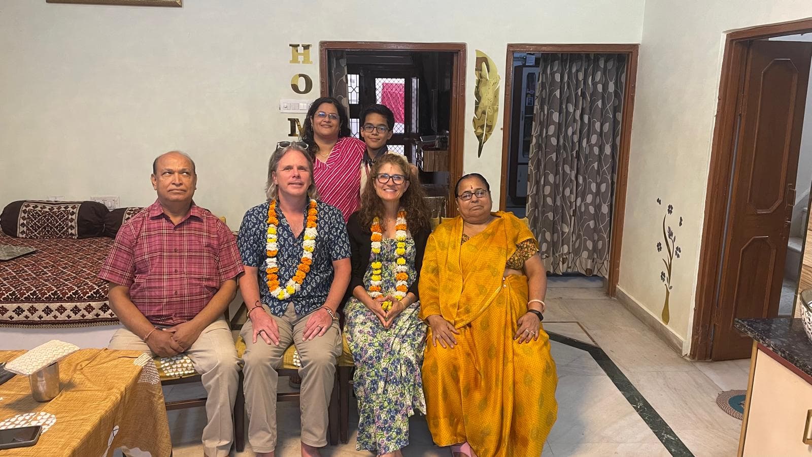 Indian family gathering celebration with yellow flower garlands Family celebration Indian home